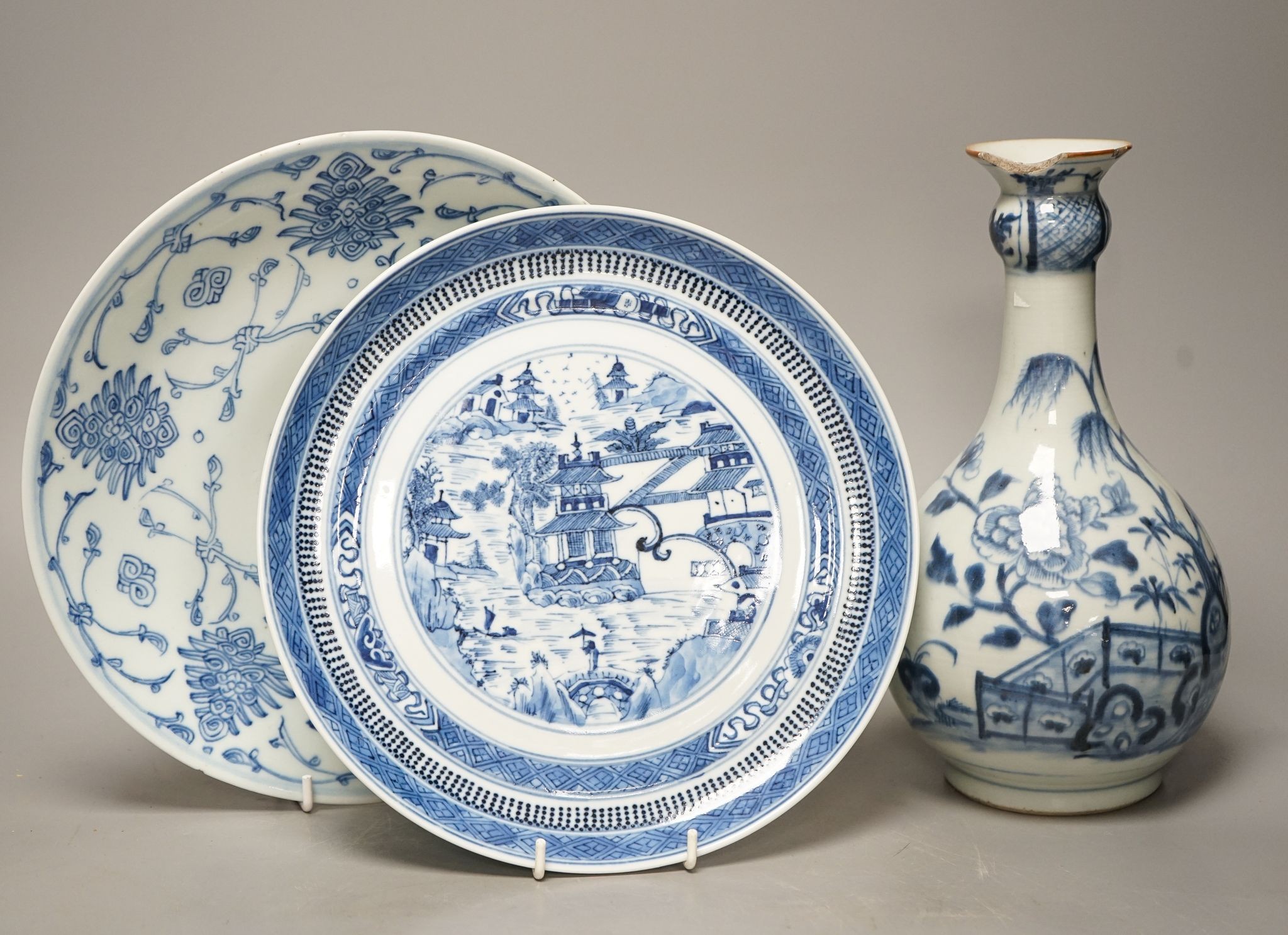 An 18th century Chinese blue and white bottle vase and two 19th century blue and white plates, diameter of largest plate - 25cm